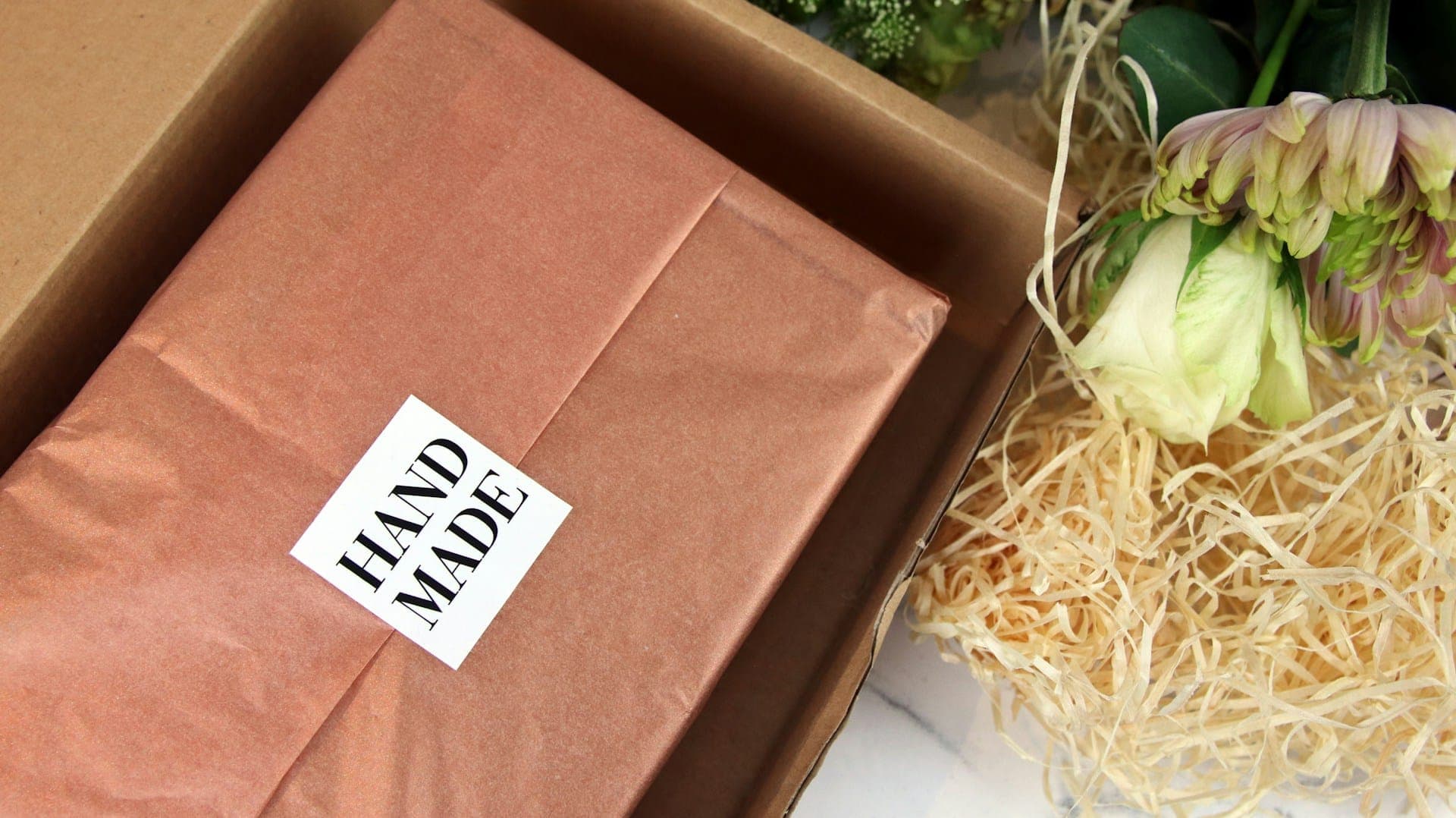 A hand-made label on a kraft parcel ready to ship.