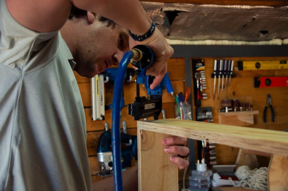 A woodworker shaping a piece of timber at the bench.